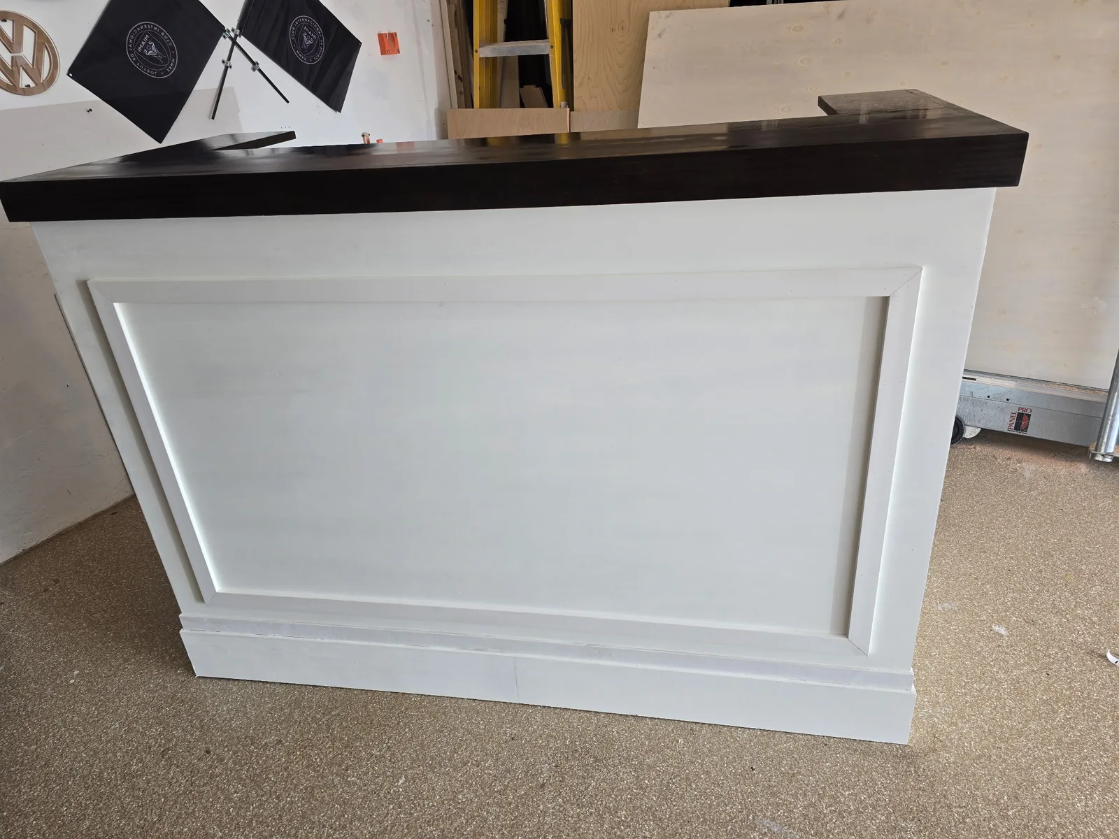 White folding event bar with dark stained countertop