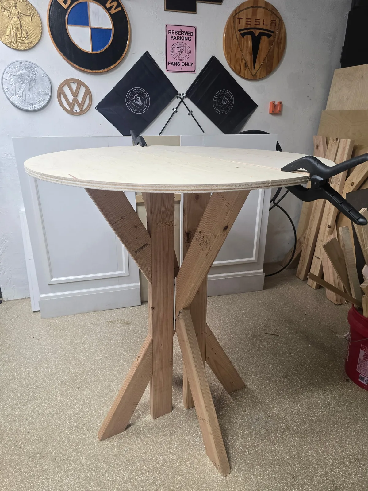 Round collapsible wooden cocktail table in the workshop